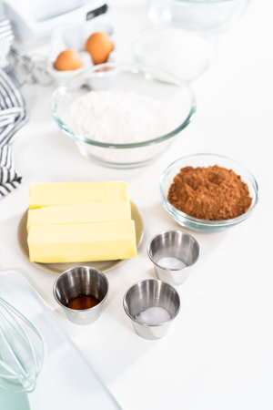 Ingredients in mixing bowls on the counter to bake chocolate cookies.の写真素材