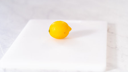 Preparing lemon swirls from the organic lemon to decorate the cocktail.の写真素材