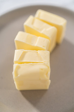 Softened sticks of unsalted butter on the kitchen counter.の写真素材