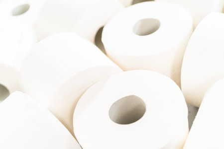 New white toilet paper rolls on a gray background.の写真素材