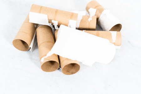 Used empty toilet paper rolls on a gray background.の写真素材