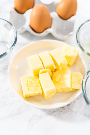 Measured ingredients in glass mixing bowls to prepare hollandaise sauce.の写真素材