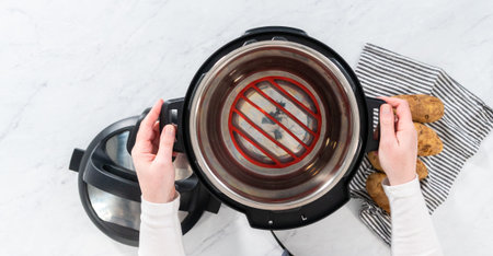 Flat lay. Pressure Cooker Baked Potatoes. Cooking whole potatoes in a pressure cooker to make baked...