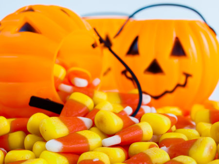 Candy corn candies falling out of Halloween treat bag.