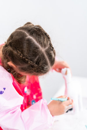 Little girl working on her art project for distance learning at home during COVID-19 pendemic.の写真素材