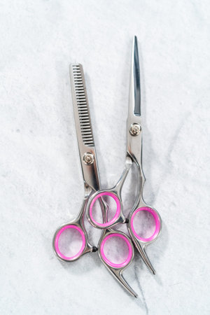 New barber pink scissors on a gray background.の写真素材