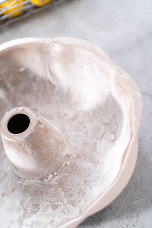 Greasing bundt cake pan to bake lemon cranberry bundt cake.の写真素材