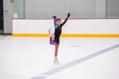 Little girl practicing before her figure skating competition at the indoor ice rink.の写真素材