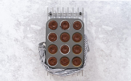 Flat lay. Cooling freshly baked smores cupcakes in a cupcake baking pan.