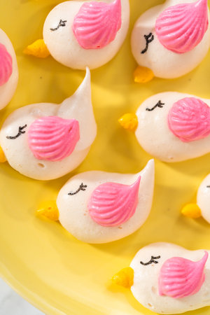Freshly baked Easter meringue cookies in the shape of birds.の写真素材