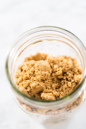 Light brown sugar on a marble counter top.の写真素材