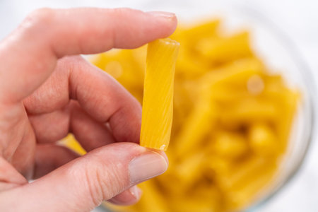 Measured ingredients in a glass mixing bowl to prepare Chicken alfredo pasta.