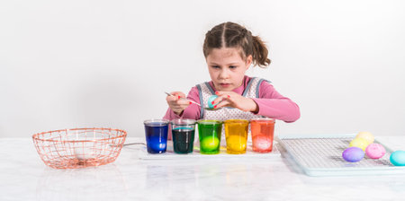 Easter egg coloring. Dye white organic eggs in different colors for Easter.
