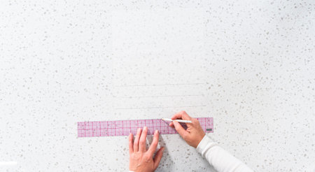 Flat lay. Preparing cutting template from parchment paper to cut homemade fudge.