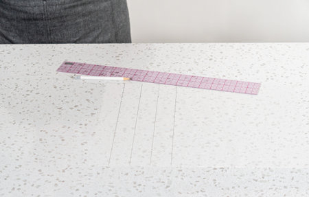 Preparing cutting template from parchment paper to cut homemade fudge.