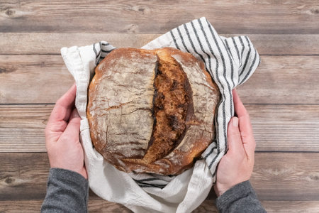 Flat lay. Freshly baked sourdough rye loaf of bread.