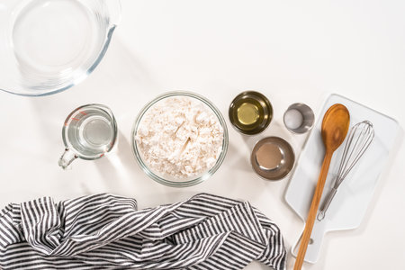 Flat lay. Ingredients in mixing bowls to make homemade flatbread.の写真素材