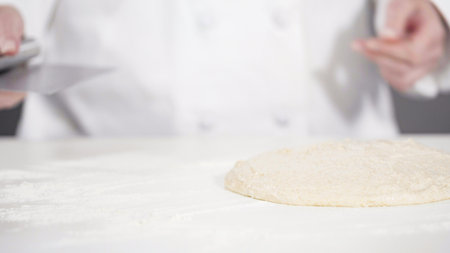 Knitting dough by hand to bake cinnamon rolls.の写真素材