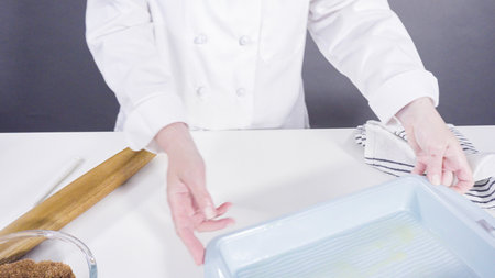 Rolling dough with a french rolling pin to bake cinnamon rolls.の写真素材