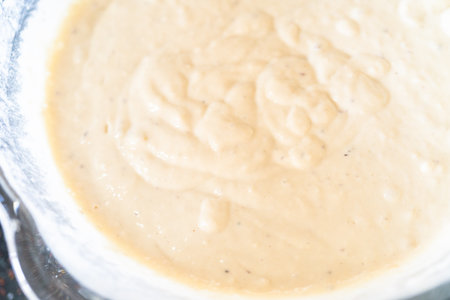 Pancake batter in a glass mixing bowl.の写真素材