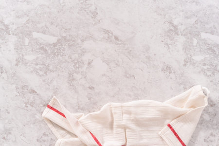 Flat lay. Empty counter with a white linen kitchen towel.の写真素材