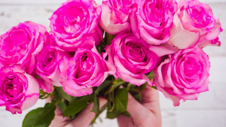Flat lay. Fresh pink roses on a wooden background.の写真素材
