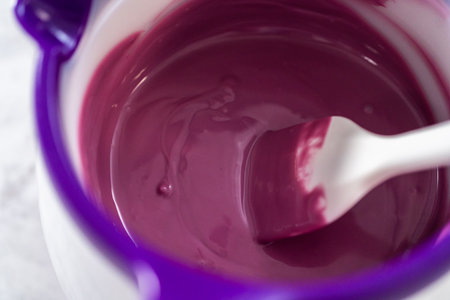 Melting chocolate chips in a candy melting pot to make mermaid pretzel twists.の写真素材