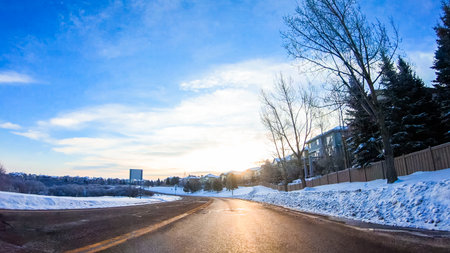 Driving through typical American suburban neighborhood on a cold Winter morning.の写真素材