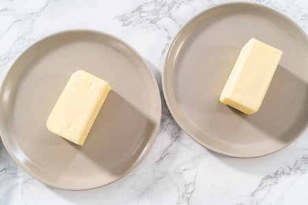Sticks of unsalted butter on the small plates.の写真素材