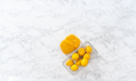 Flat lay. Lemon wedge cookies with lemon glaze. Wrapping cookie dough for chilling in the refrigerator to bake lemon wedge cookies with lemon glaze.の写真素材