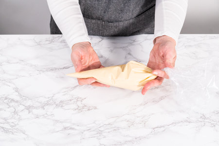Pancake batter in a piping bag to prepare mini pancake cereal.の写真素材
