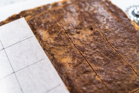 Scoring chocolate peanut butter fudge for cutting into small pieces.の写真素材