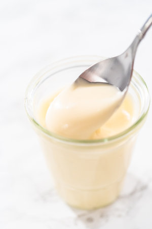 Eggnog glaze in a small glass jar.の写真素材