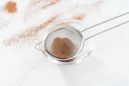 Mixing ingredients in a glass mixing bowl to bake chocolate graham crackers.