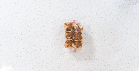 Flat lay. Meal prepping. Packaging banana oatmeal muffins into the plastic back to store in a...