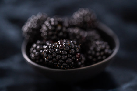 Fresh organic blackberries on ablack marble surface.の写真素材