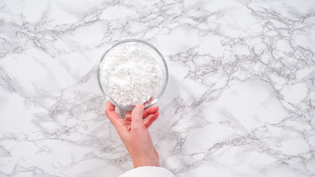 Step by step. Flat lay. Ingredients in a glass mixing bowls to make unicorn meringue cookies.