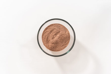 Flat lay. Mixing ingredients in a large glass mixing bowl to bake homemade hot chocolate mix.