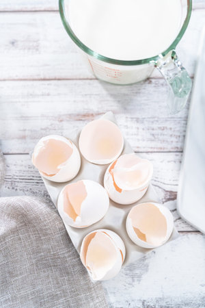 Empty egg shells from organic white eggs in ceramic egg crates.