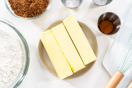 Ingredients in mixing bowls on the counter to bake chocolate cookies.の写真素材