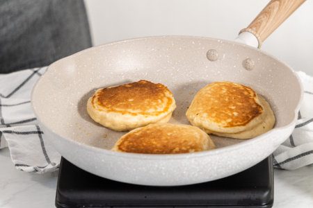 Preparing eggnog pancakes in a nonstick frying pan.