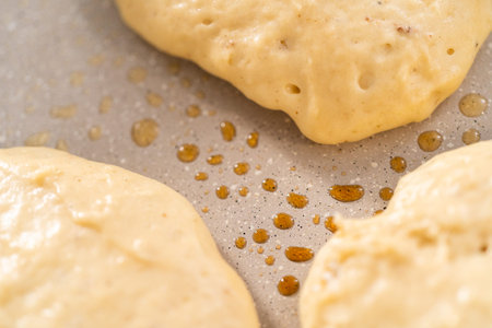 Preparing eggnog pancakes in a nonstick frying pan.