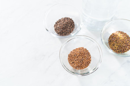 Day 1. Variety of seeds in a small glass bowl for growing sprouts in a jar.の写真素材