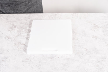 Sliced homemade pumpkin bread on a white cutting board.の写真素材