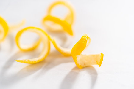 Preparing lemon swirls from the organic lemon to decorate the cocktail.の写真素材