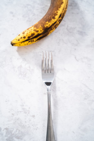 Mashing overhyped banana with a fork.