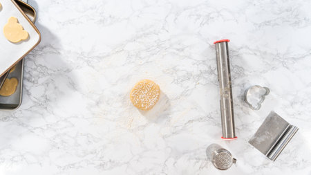 Flat lay. Rolling cookie dough and cutting out panda-shaped shortbread cookies.の写真素材
