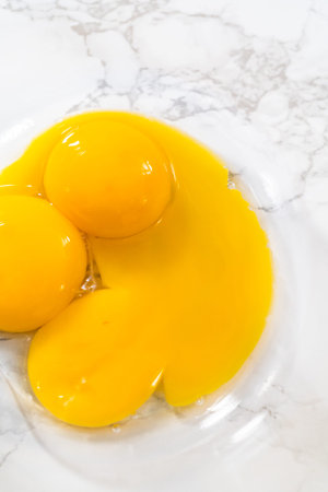 Separating egg whites and yolks to bake meringue cookies.