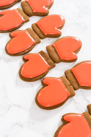 Decorating Christmas gingerbread cookies with royal icing.