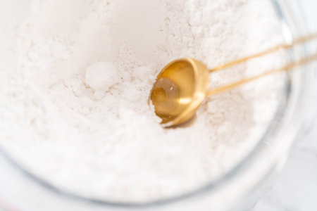 Mixing in store-bought buttercream frosting in a glass mixing bowl.の写真素材